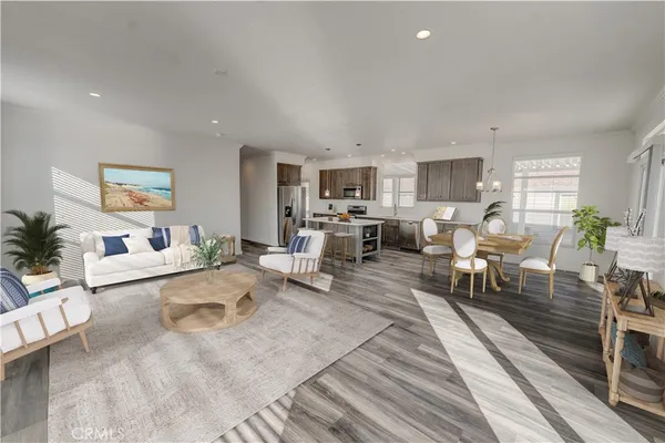 a living room with furniture and a dining table with kitchen view