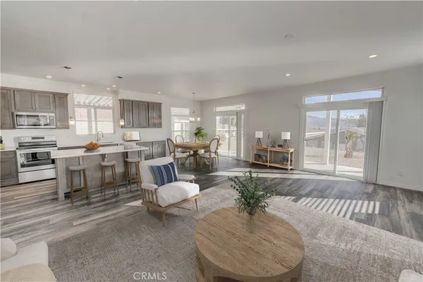 a living room with lots of furniture and kitchen view