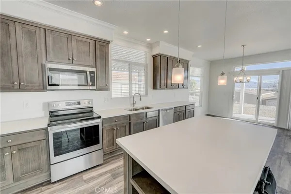 a kitchen with a stove a sink and a microwave