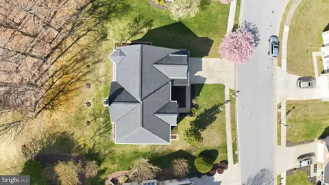 an aerial view of a house with a yard