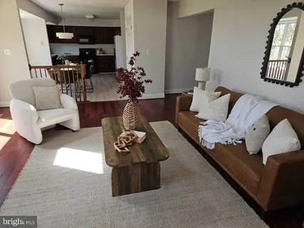 a living room with furniture and flowers