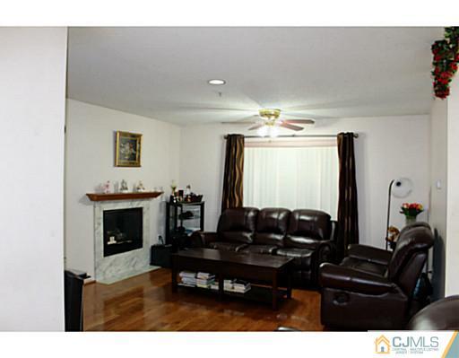 2 Inverness Drive Edison, NJ 08820 - Photo 2 of 14 a living room with furniture a fireplace and a flat screen tv