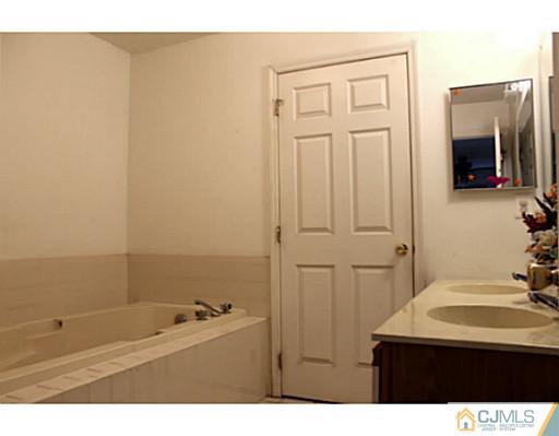 2 Inverness Drive Edison, NJ 08820 - Photo 6 of 14 a bathroom with a sink and a mirror