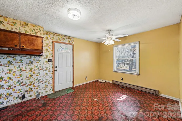 a view of a livingroom with wooden floor and a ceiling fan