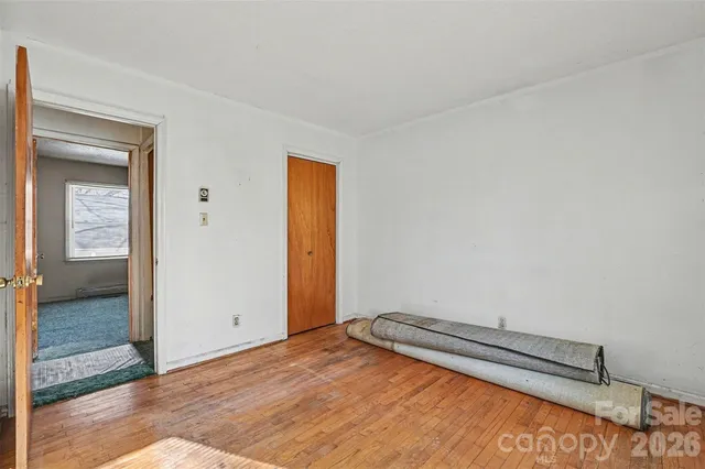 a view of room with wooden floor