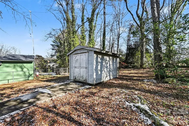 a small house with a trees in the background