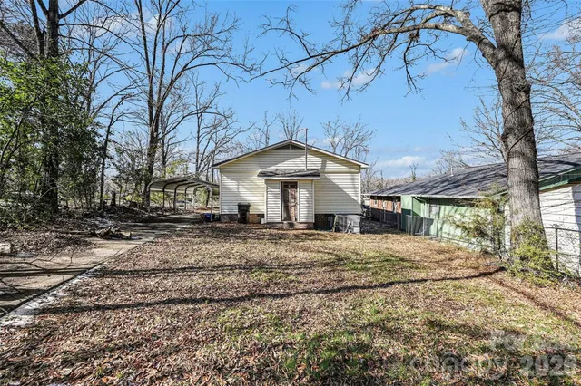a view of a house with a yard covered in snow