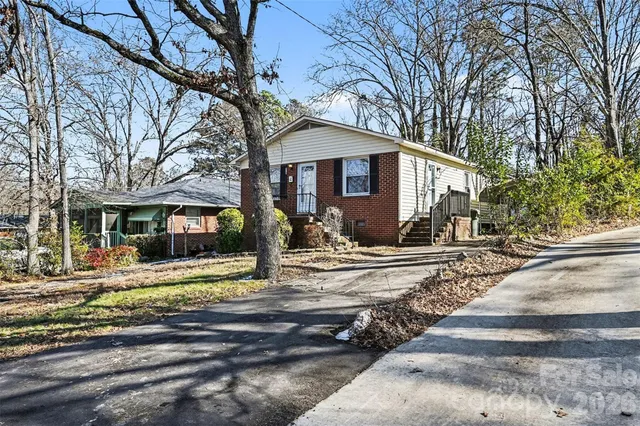 a view of a house with a yard covered in snow