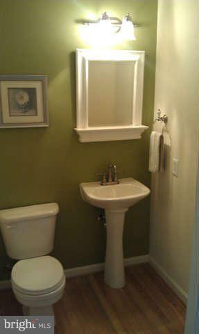 2413 High Brandy Way Odenton, MD 21113 - Photo 6 of 6 a bathroom with a toilet sink and mirror