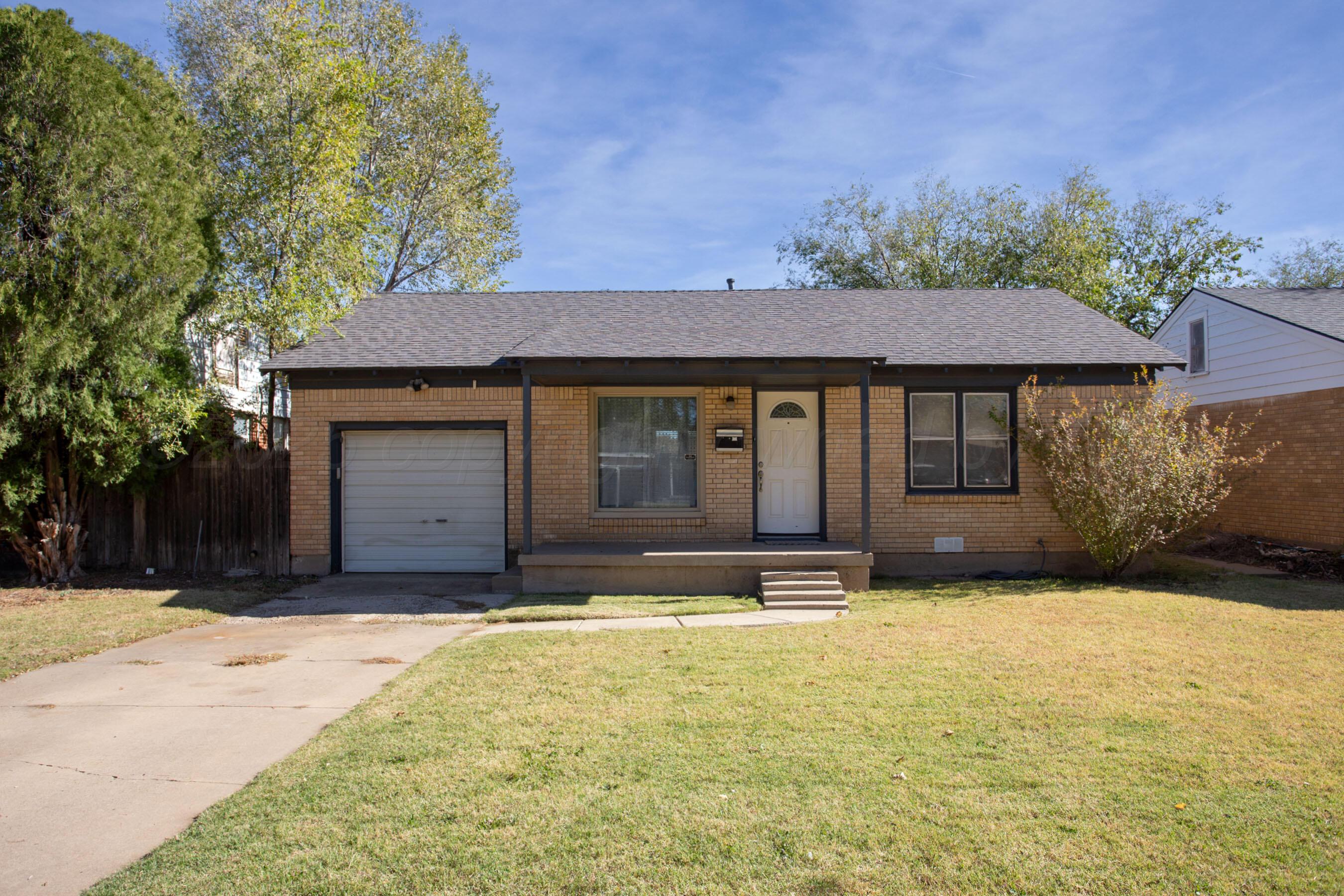 4215 South Travis Street Amarillo, TX 79110 - Photo 1 of 20 a front view of a house with a yard