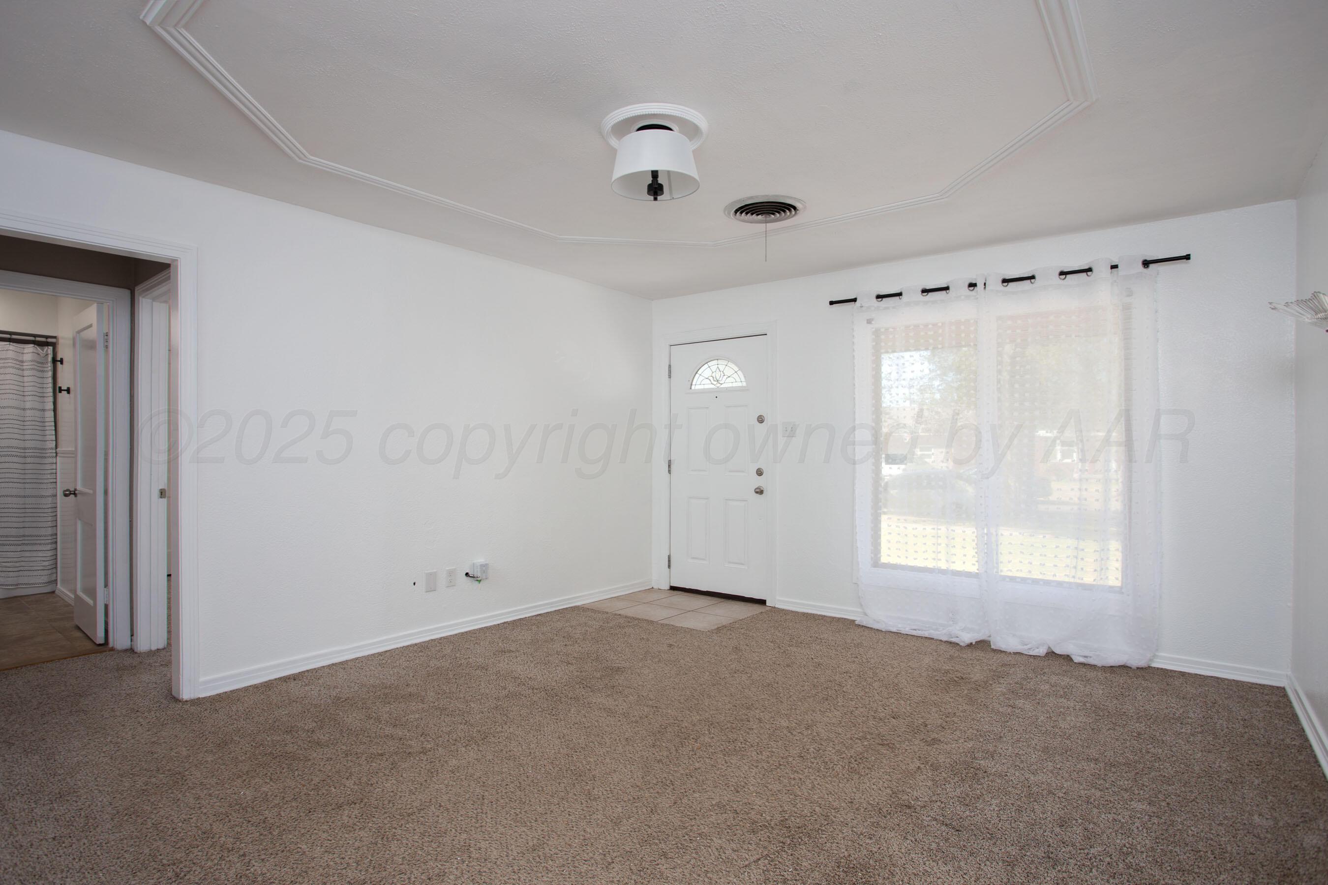 4215 South Travis Street Amarillo, TX 79110 - Photo 11 of 20 a view of an empty room with a window