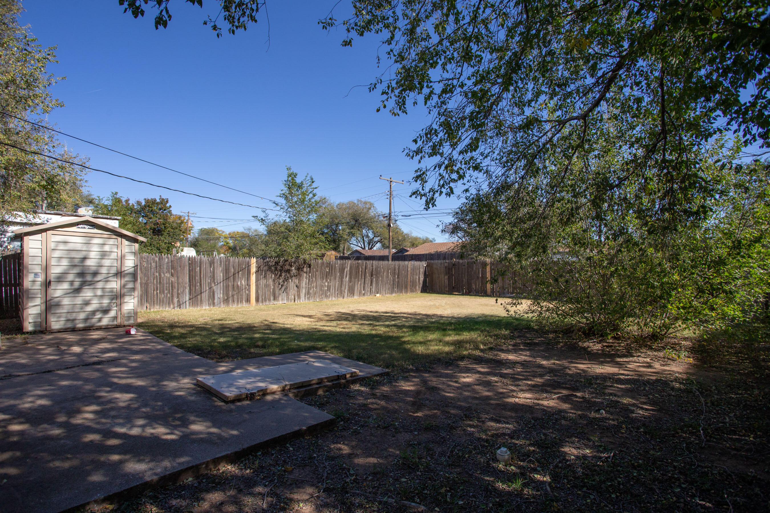 4215 South Travis Street Amarillo, TX 79110 - Photo 19 of 20 a view of a yard with plants and trees