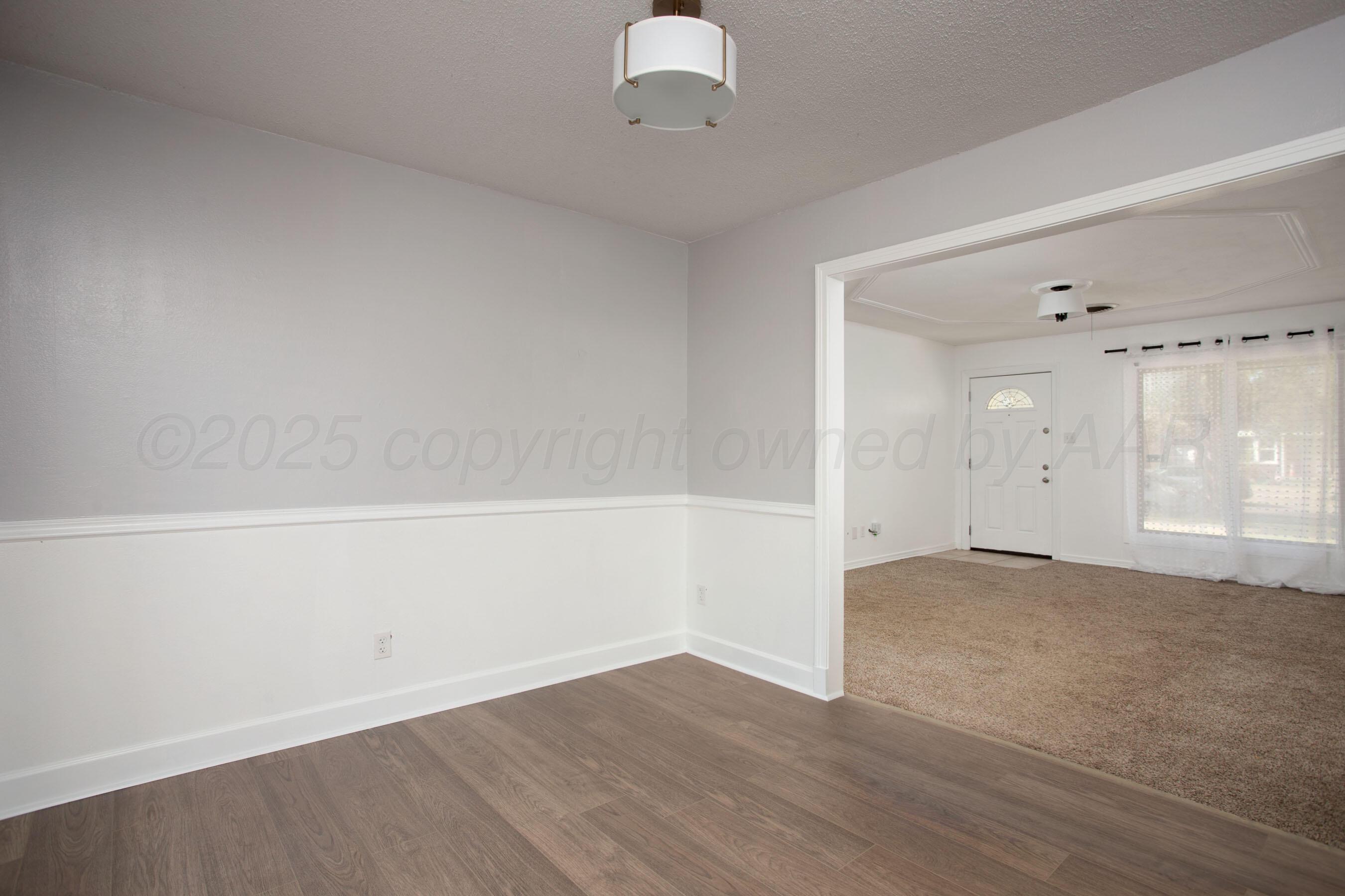 4215 South Travis Street Amarillo, TX 79110 - Photo 6 of 20 a view of an empty room with a window