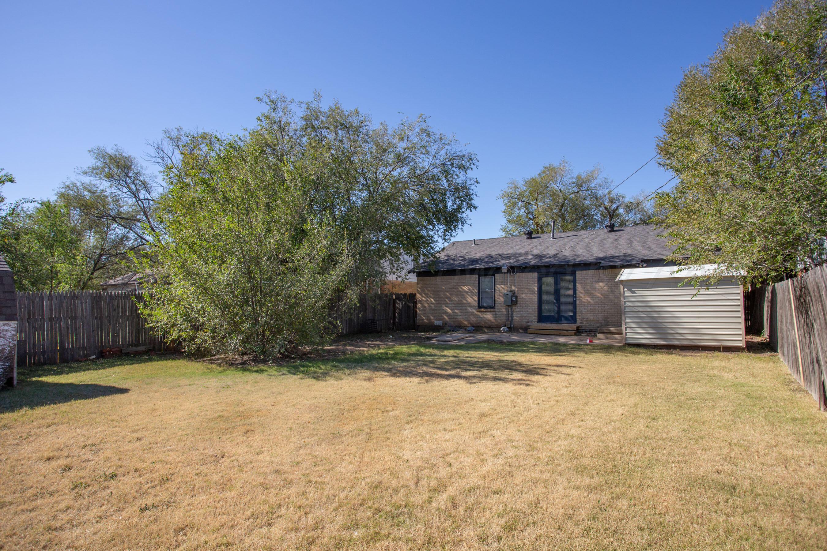 4215 South Travis Street Amarillo, TX 79110 - Photo 9 of 20 a view of a house with yard and a tree