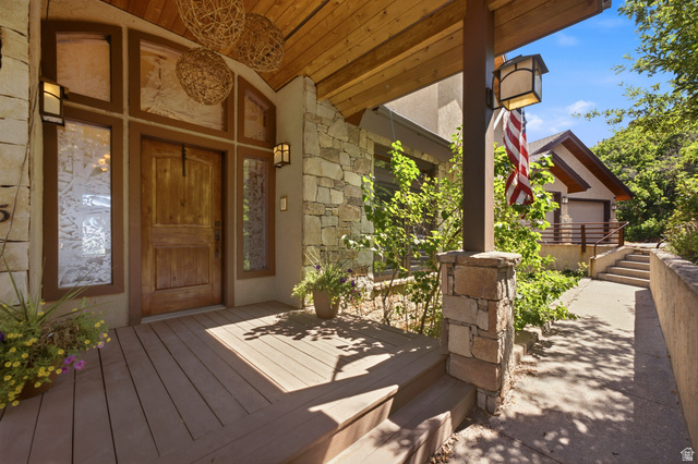 335 Bern Way Midway, UT 84049 - Photo 8 of 88 Rustic wood-finish porch featuring stone veneer accents and a robust wood entry door with decorative glass sidelights and transom