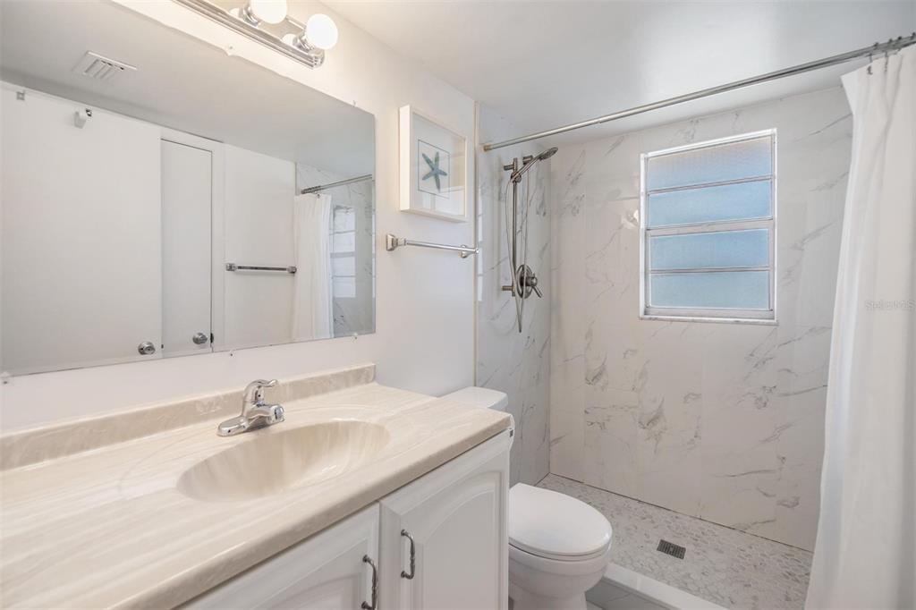 12760 Indian Rocks Road, Unit 104 Largo, FL 33774 - Photo 18 of 37 a bathroom with a sink toilet and shower