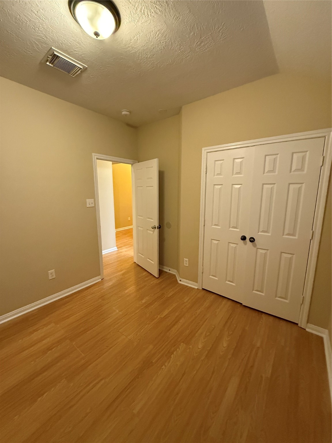 22031 Falvel Drive Spring, TX 77389 - Photo 16 of 21 an empty room with wooden floor and windows