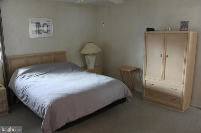 a bed sitting in a bedroom next to a cabinet