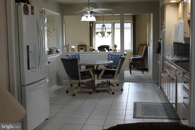 a view of a dining room with furniture and a chandelier