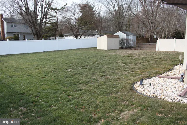 a view of a white house with a yard
