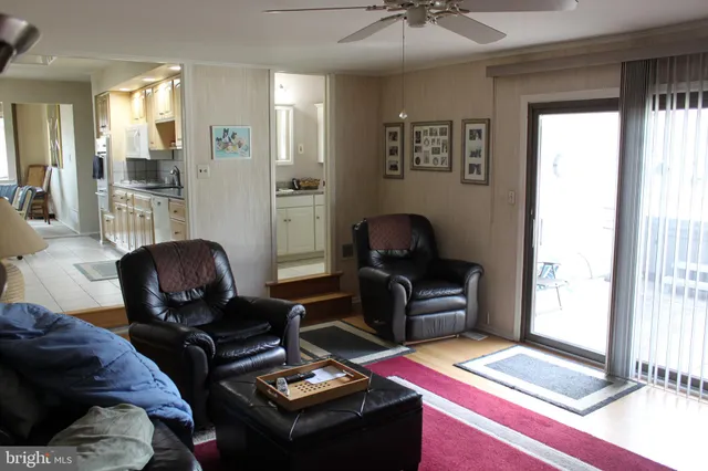 a living room with furniture and next to a window