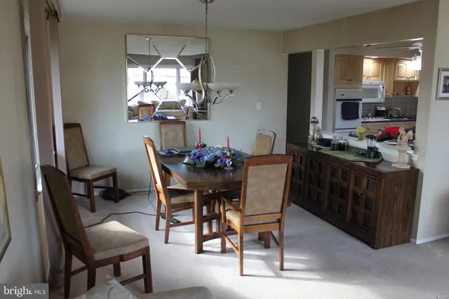 a dining room with furniture and chandelier