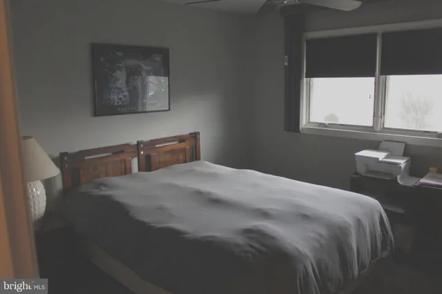 a bedroom with a bed and window