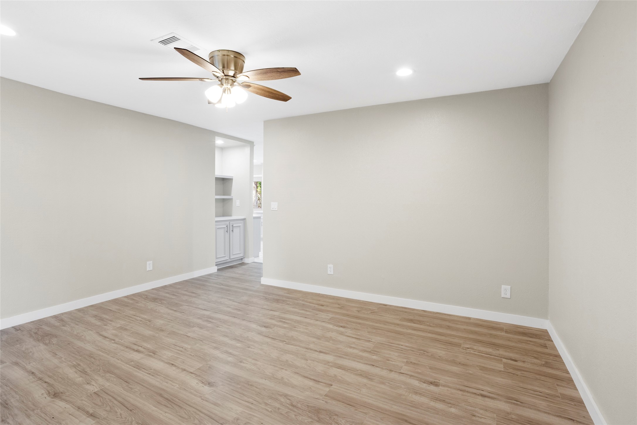 10127 Tolman Street Houston, TX 77034 - Photo 4 of 27 To the right, a large opening without a door suggests a formal dining room or living space that shares the same flooring and wall color.