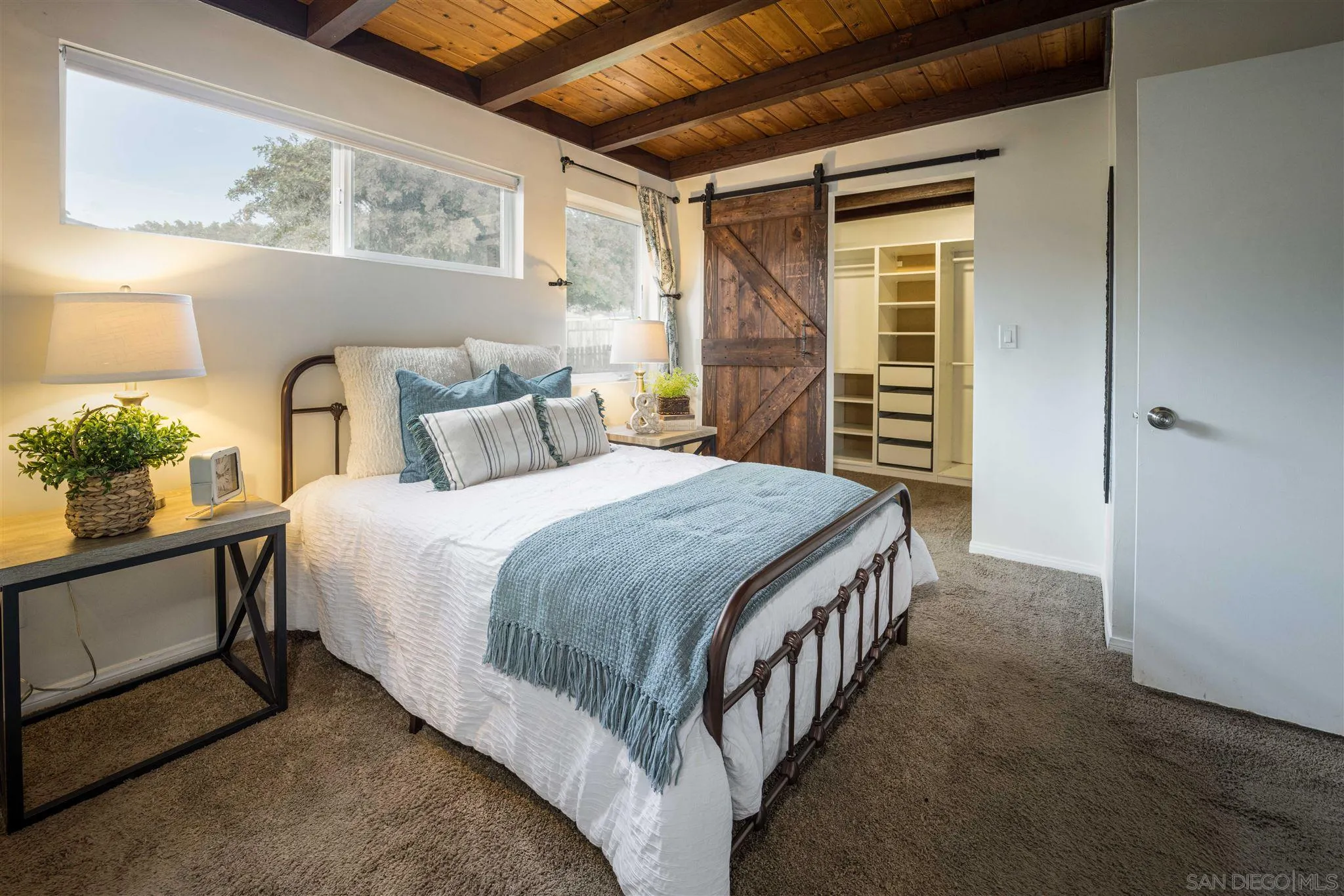 962 Wilfred Street El Cajon, CA 92021 - Photo 12 of 27 a bedroom with a large bed and a potted plant