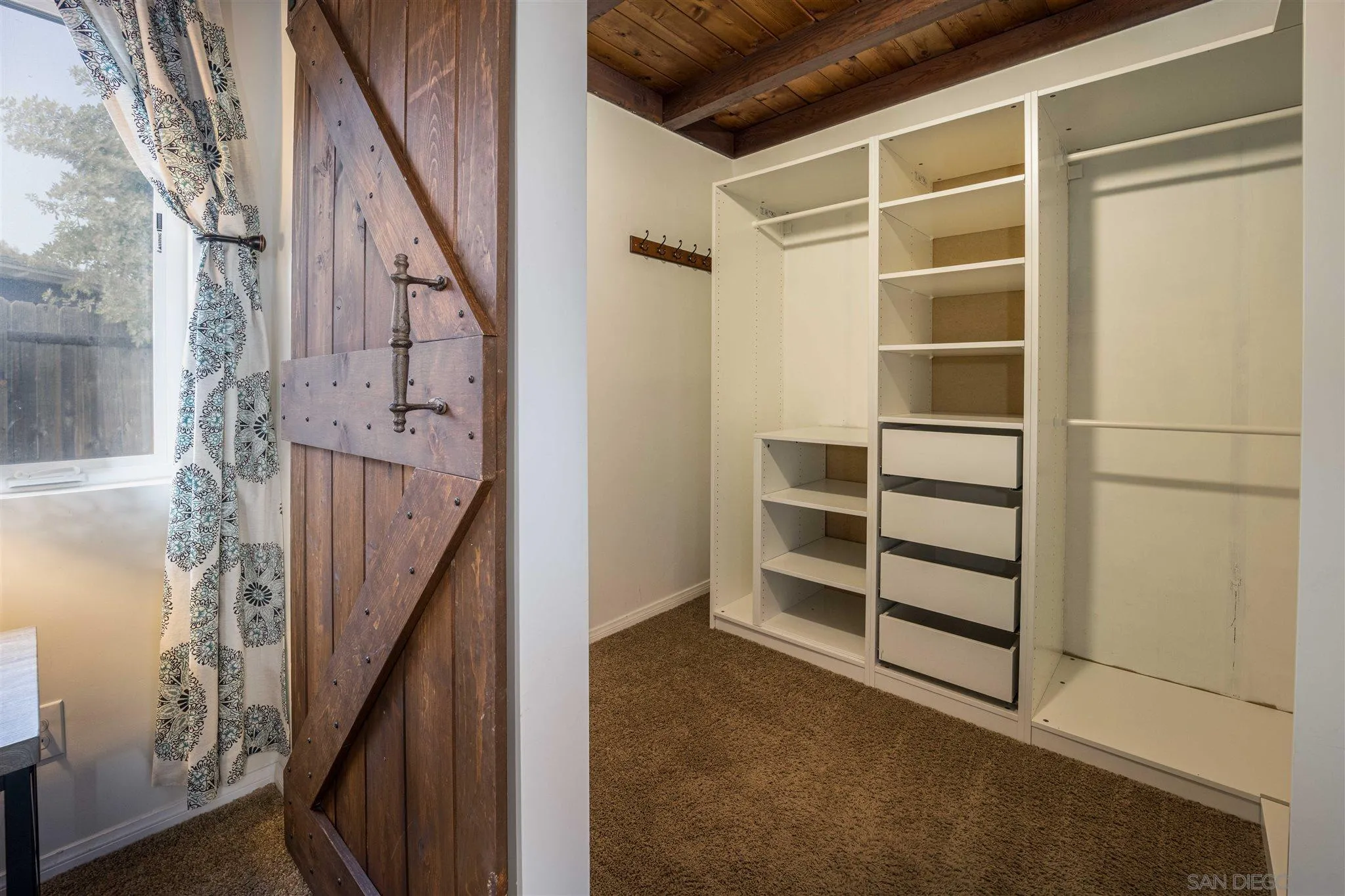 962 Wilfred Street El Cajon, CA 92021 - Photo 13 of 27 a view of walk in closet with empty racks