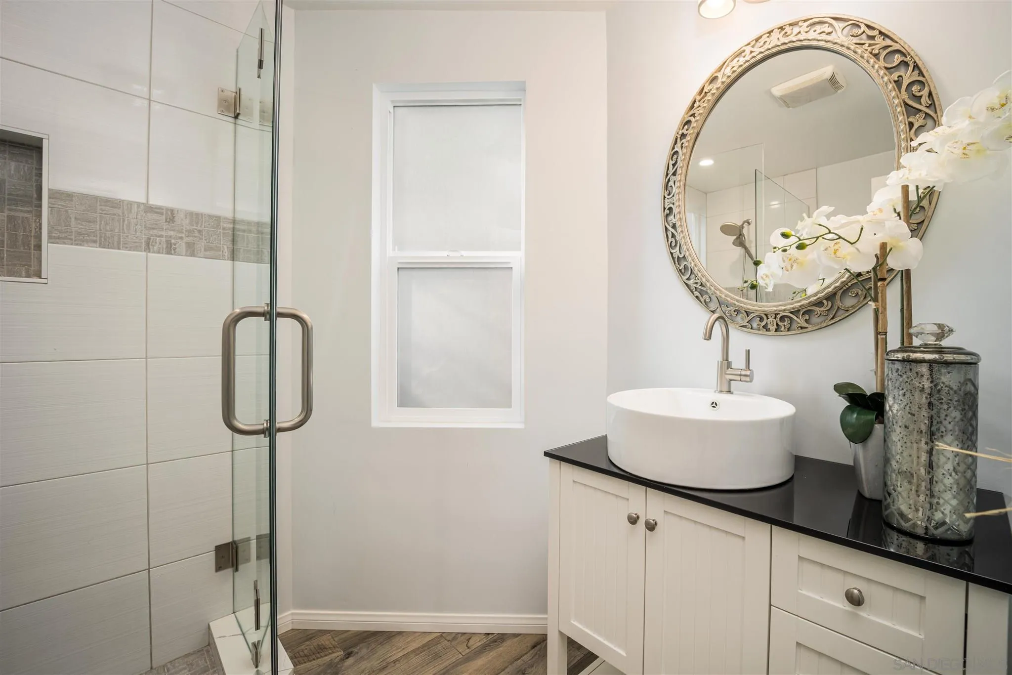 962 Wilfred Street El Cajon, CA 92021 - Photo 15 of 27 a bathroom with a sink and a mirror