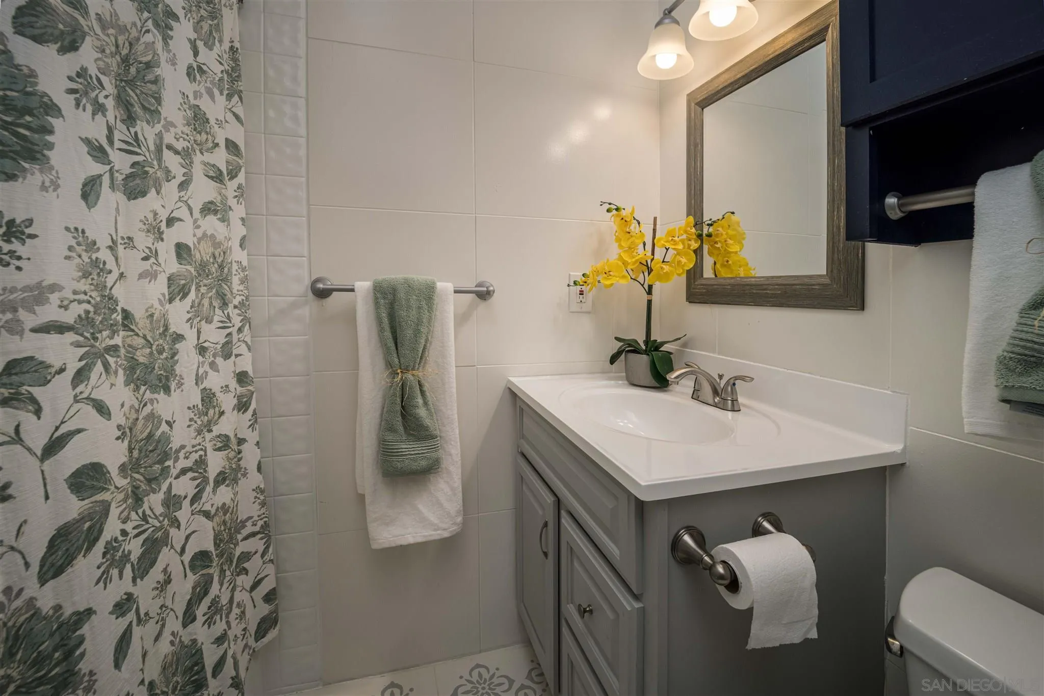 962 Wilfred Street El Cajon, CA 92021 - Photo 18 of 27 a bathroom with a sink and mirror