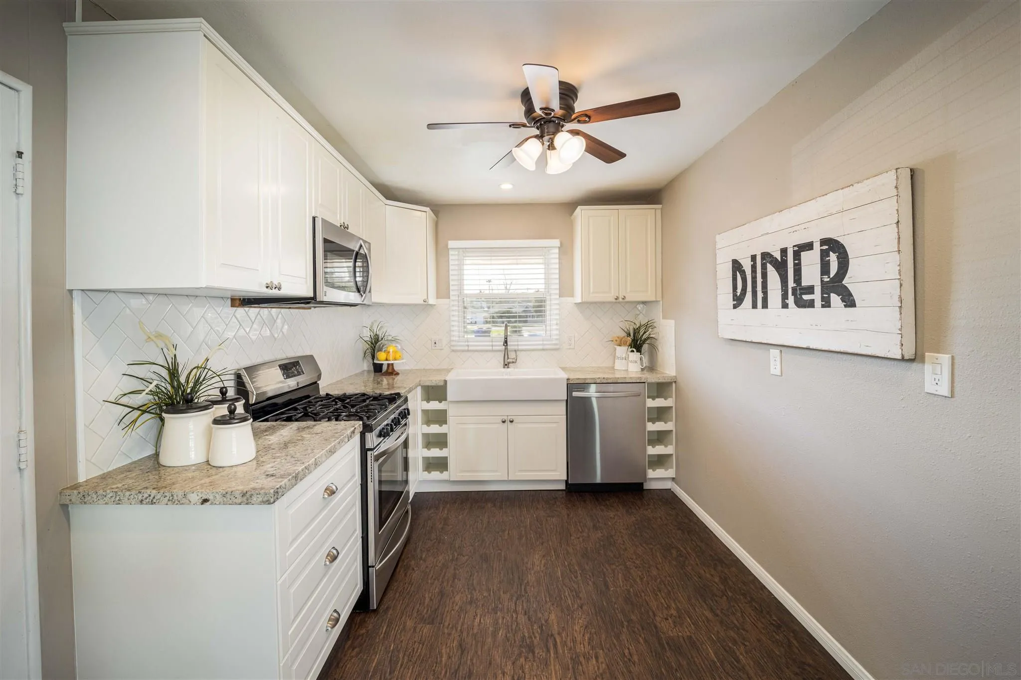 962 Wilfred Street El Cajon, CA 92021 - Photo 20 of 27 a kitchen with a sink stove and cabinets
