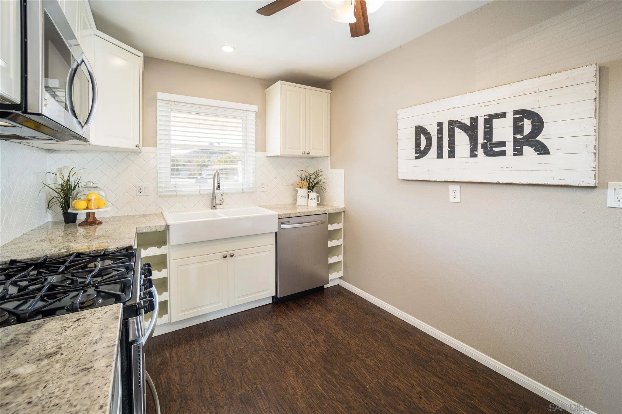 962 Wilfred Street El Cajon, CA 92021 - Photo 22 of 27 a view of a kitchen with fridge and wooden floor