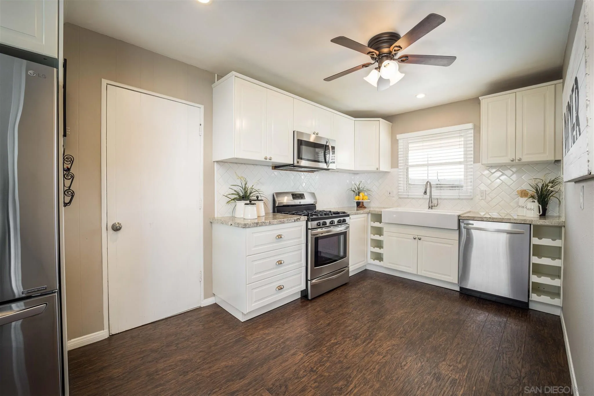 962 Wilfred Street El Cajon, CA 92021 - Photo 5 of 27 a kitchen with cabinets stainless steel appliances and a window
