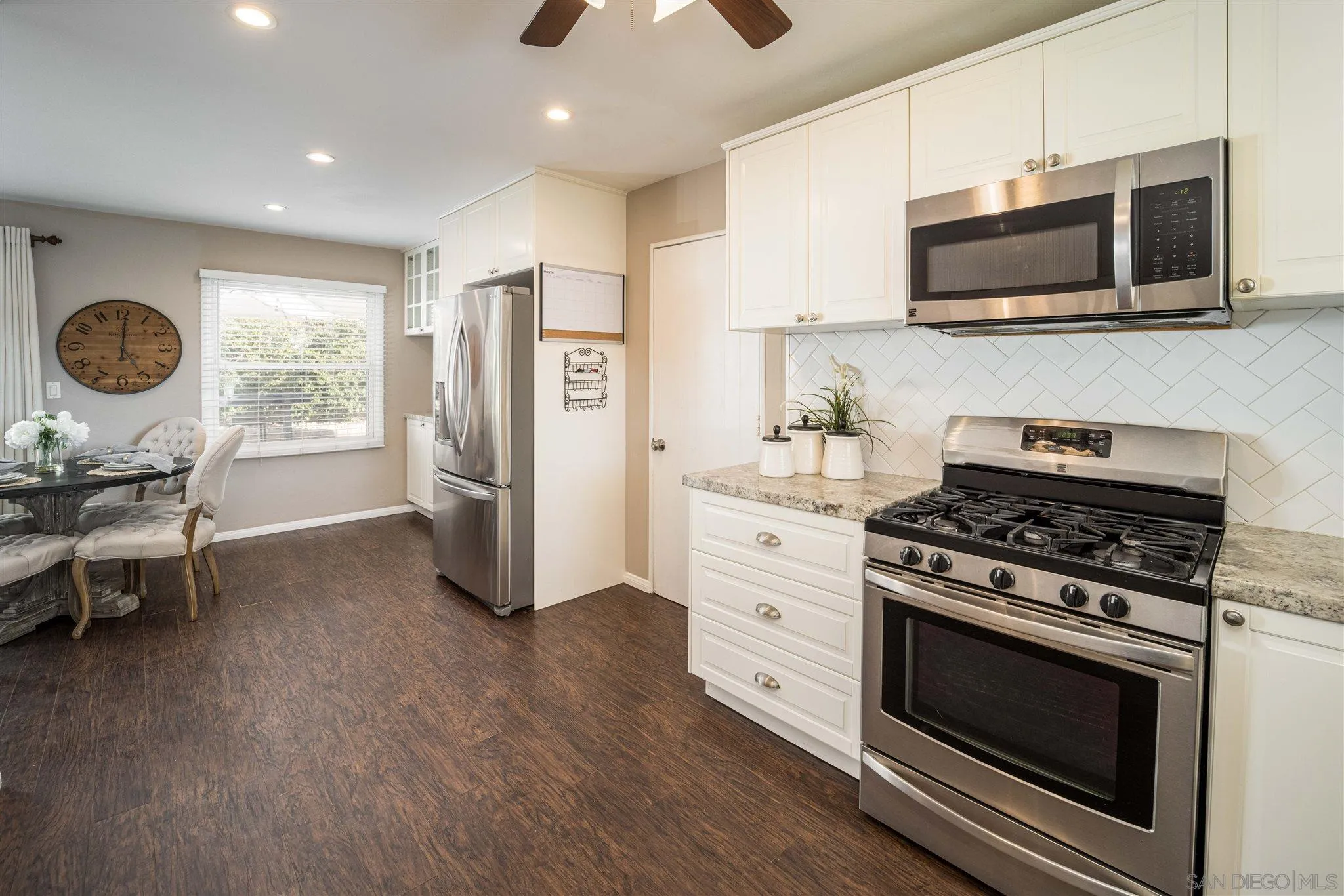 962 Wilfred Street El Cajon, CA 92021 - Photo 6 of 27 a kitchen with stainless steel appliances a stove a microwave and cabinets