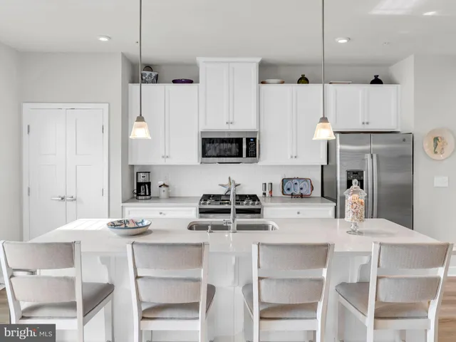 a spacious bedroom with a bed and a chandelier