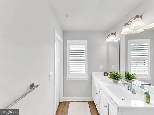 a bathroom with a sink mirror vanity and toilet