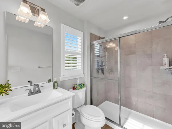 a bathroom with a glass shower door