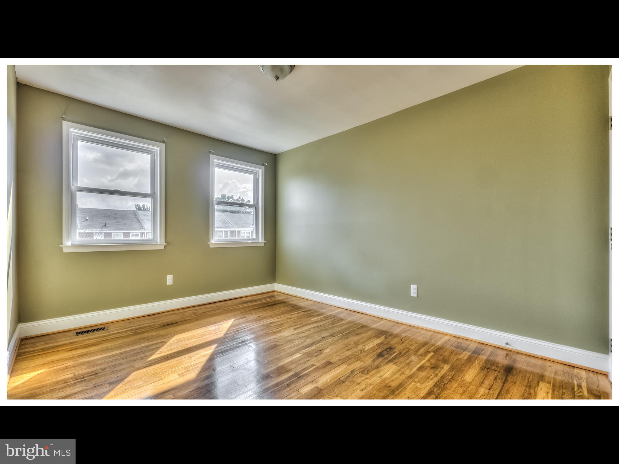 836 Bradhurst Road Baltimore, MD 21212 - Photo 20 of 24 a view of an empty room with wooden floor and a window