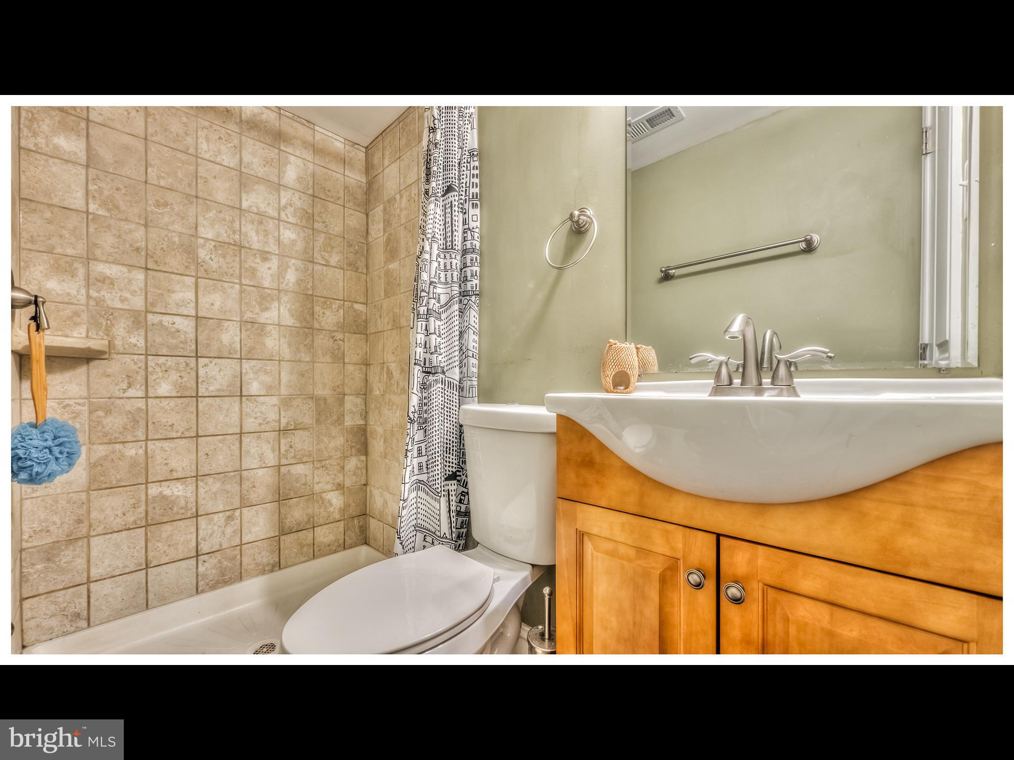 836 Bradhurst Road Baltimore, MD 21212 - Photo 24 of 24 a bathroom with a sink a toilet and shower