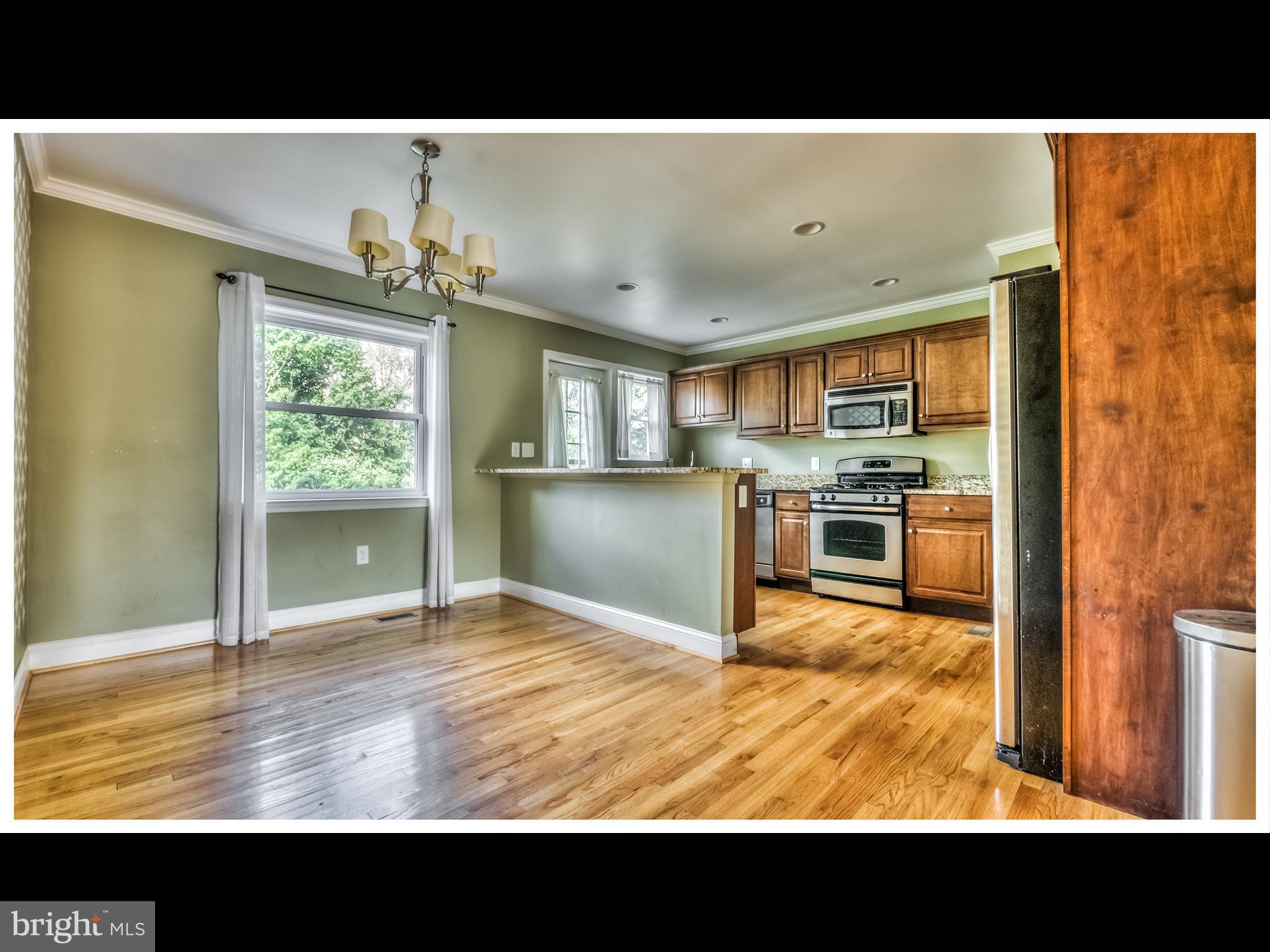 836 Bradhurst Road Baltimore, MD 21212 - Photo 5 of 24 a view of open kitchen with kitchen island granite countertop a refrigerator stove top oven and sink