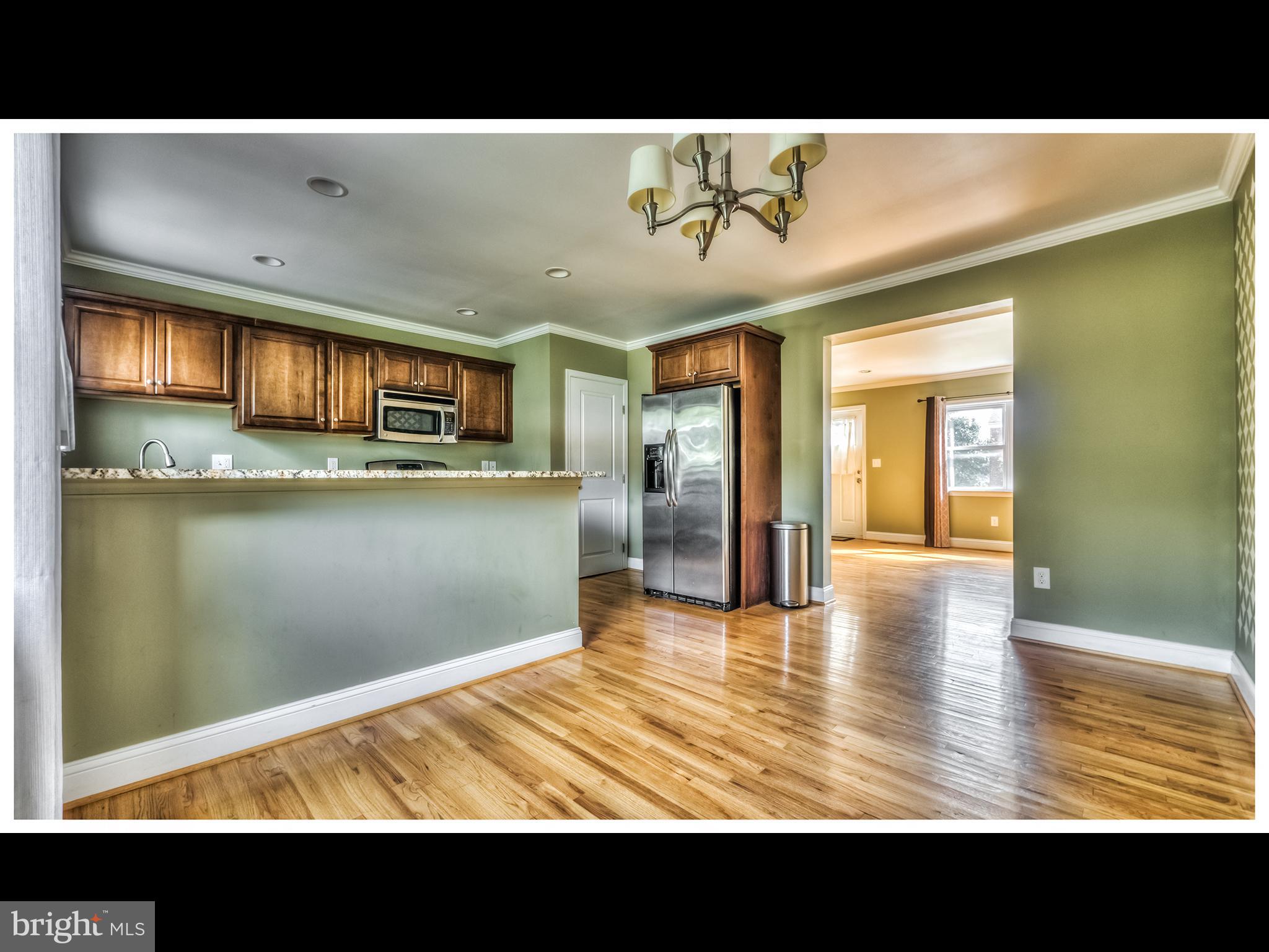 836 Bradhurst Road Baltimore, MD 21212 - Photo 6 of 24 a view of a living room and kitchen with a large window