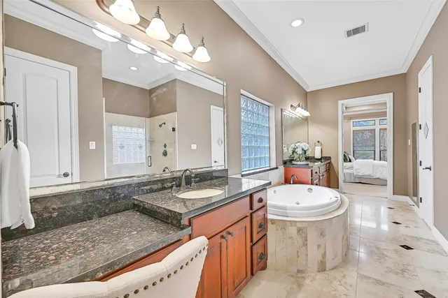 a bathroom with a sink a toilet a mirror and shower