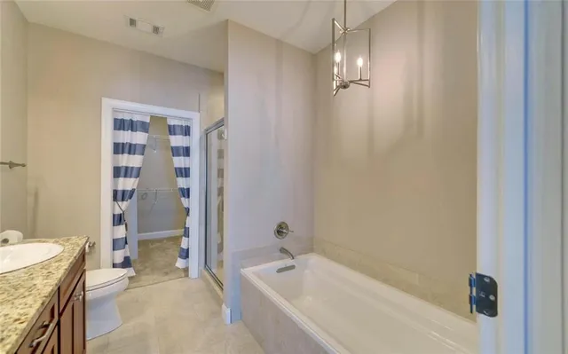 a bathroom with a tub a sink and shower