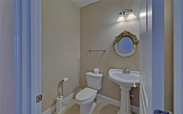 a view of wooden floor and a chandelier fan in a room