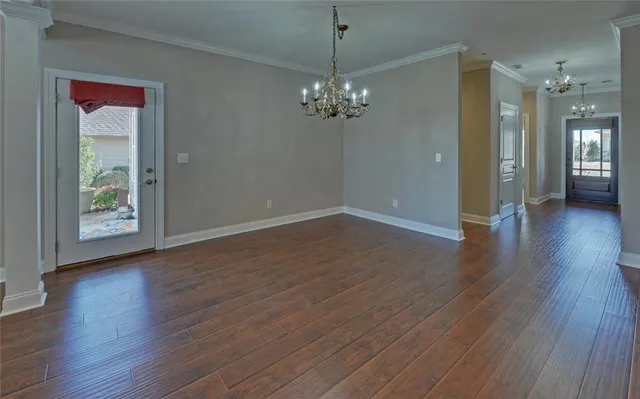 a view of a livingroom with wooden floor and a chandelier