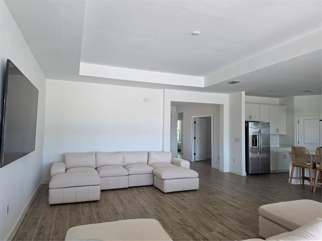 18334 Ridgeline Drive Estero, FL 33928 - Photo 7 of 30 a living room with furniture and a flat screen tv