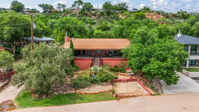 an outdoor space with seating area and trees