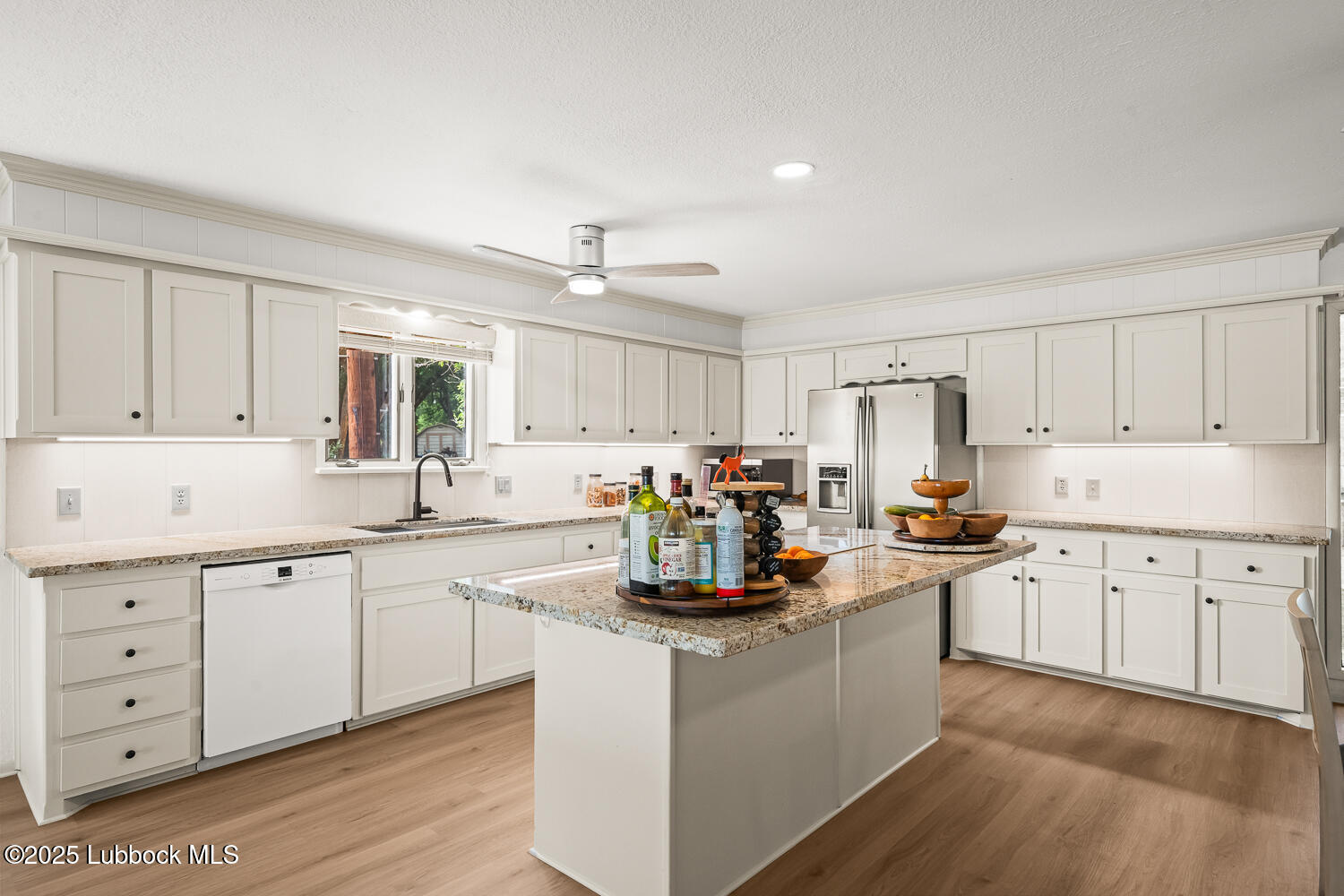 146 Pony Express Trail Buffalo Springs, TX 79404 - Photo 10 of 48 a kitchen with sink a stove and cabinets